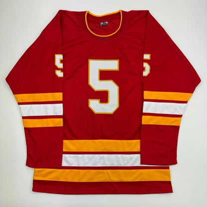 Red custom jersey from professional sports league featuring white and gold number 5