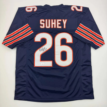 Navy blue professional sports league custom jersey with SUHEY 26 autograph and orange stripes