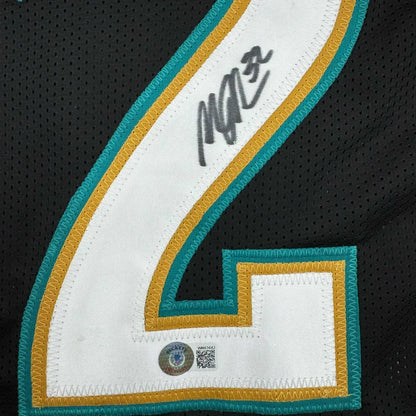 Autographed Maurice Jones-Drew custom jersey, black mesh with white 2 in teal gold, professional sports league