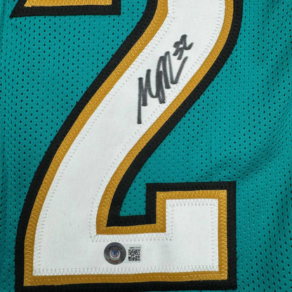 Autographed teal professional sports league jersey with black and gold number 2