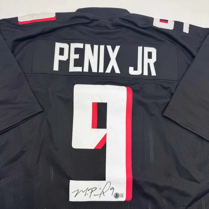 Back view of autographed Michael Penix Jr. black football custom jersey with white and red accents from professional sports league