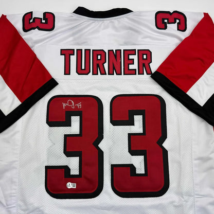 Autographed Michael Turner Atlanta White Football Jersey Beckett BAS COA | Certified Authentic Signed Memorabilia | vintageantiquesgifts.com