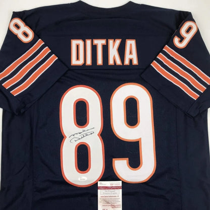 Signed navy blue custom jersey from a professional sports league with orange and white numbers
