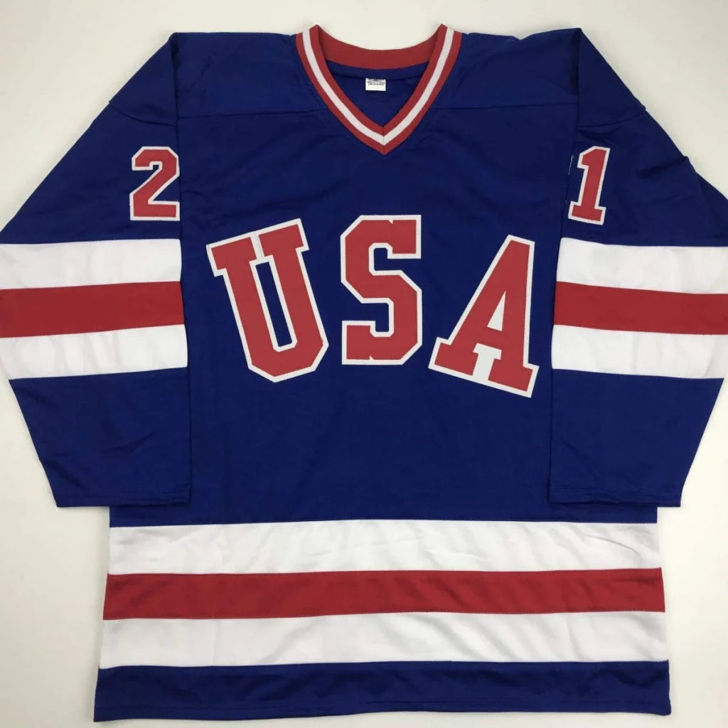 Autographed mike eruziño custom blue team USA hockey jersey with red white stripes and numbers 1 and 2 on sleeves