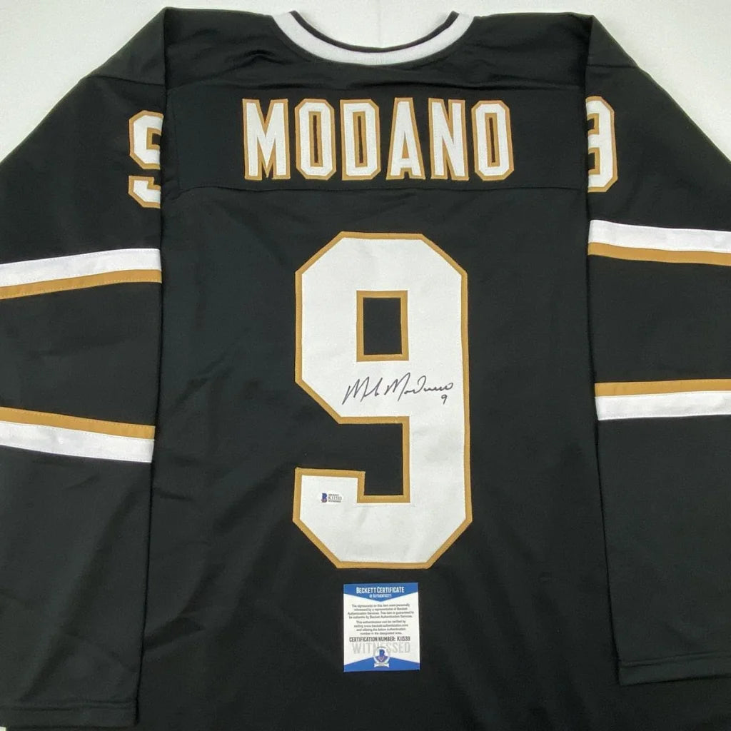 Black Mike Modano Dallas jersey signed by the player, perfect for professional sports fans