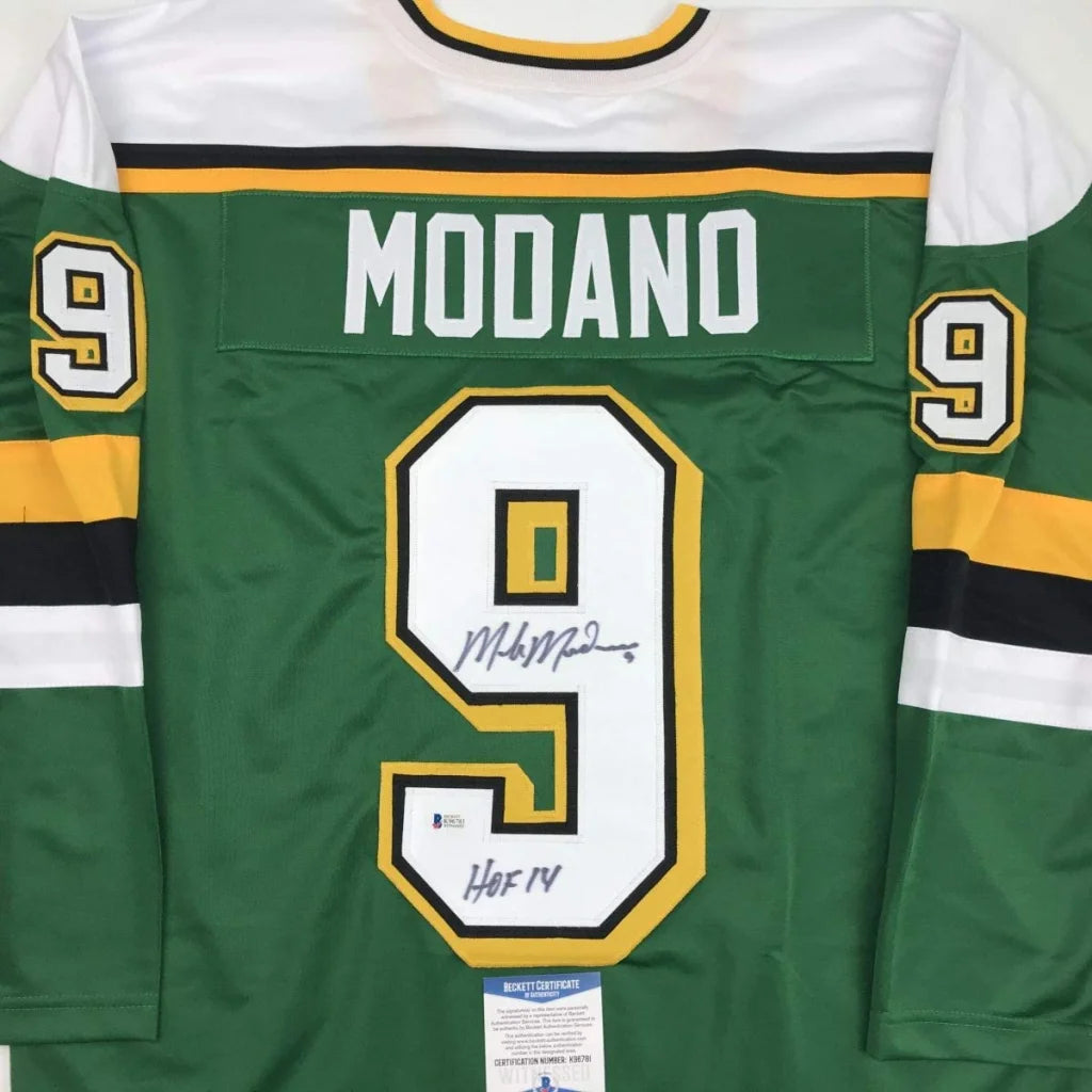 Green and white hockey jersey with yellow trim, featuring the name ’modano’ and number 9 in bold lettering across the back.
