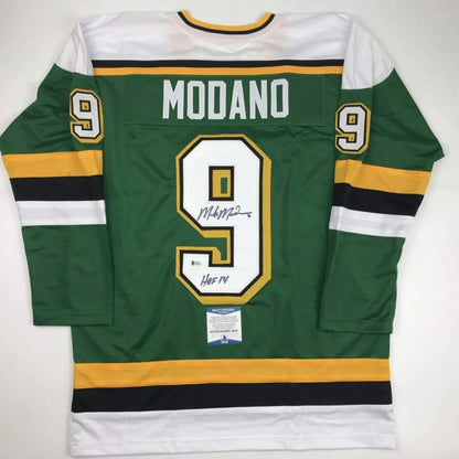 Back of autographed Mike Modano custom green jersey, number 9, professional sports league