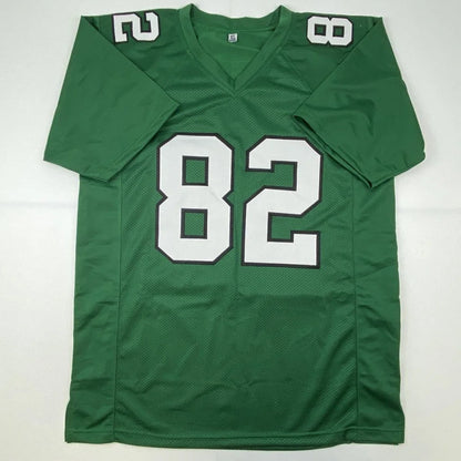 Green mesh custom jersey with white number 82 and v-neck collar for professional sports league signed by mike quick
