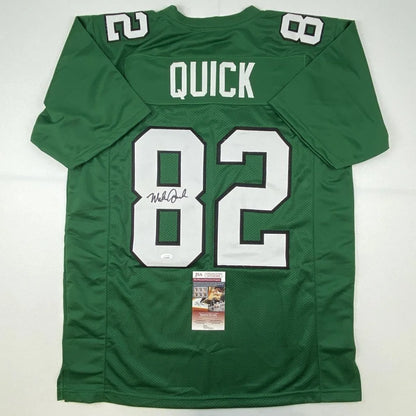 Back side of a green custom football jersey with white number 82 quick name and autograph from professional sports league player mike quick