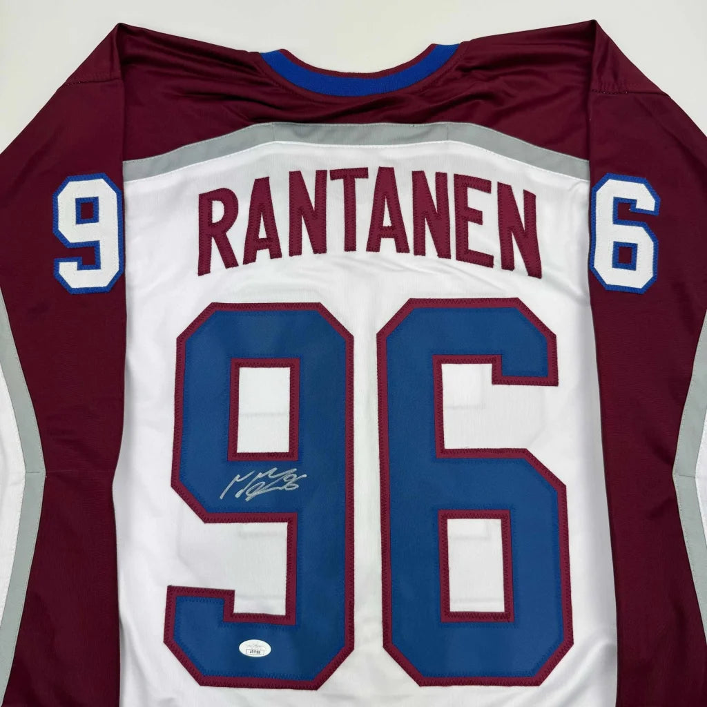 Autographed white, maroon, and blue Mikko Rantanen professional sports league custom jersey