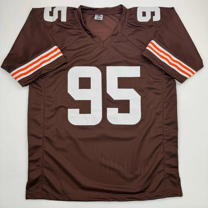 Brown football jersey with white 95, orange and white stripes, perfect for pro sports fans