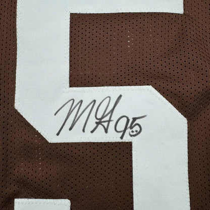 Brown sports jersey with white number and autograph from a professional sports league