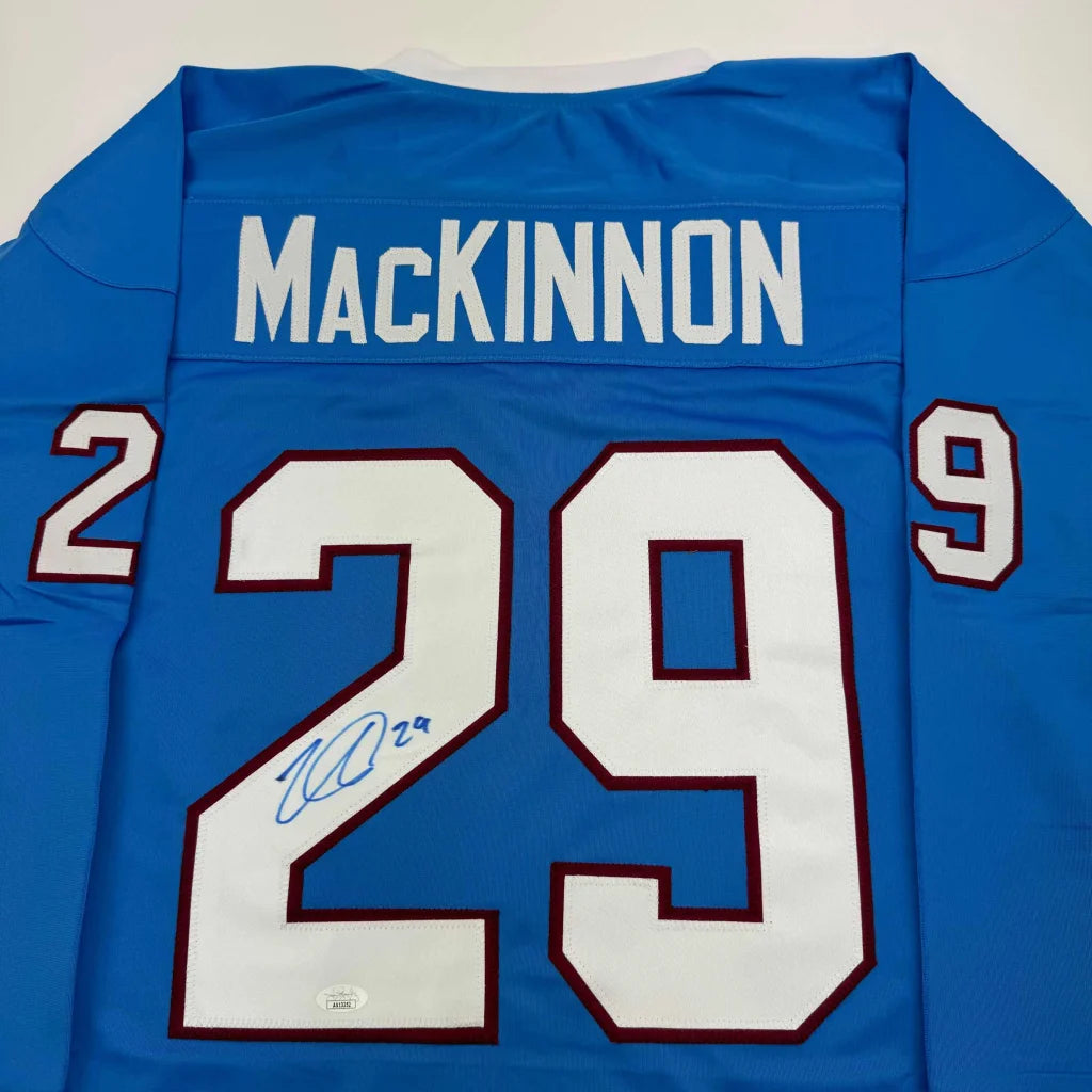 Light blue custom hockey jersey with white numbers and signature from professional sports league