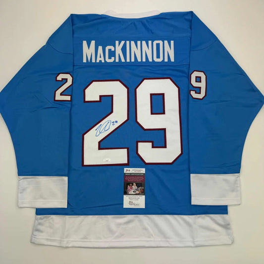 Autographed Nathan MacKinnon custom jersey from professional sports league display