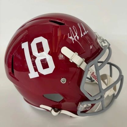 Glossy crimson Alabama Crimson Tide full size football helmet with white number 18, signature, gray faceguard, and white chin strap