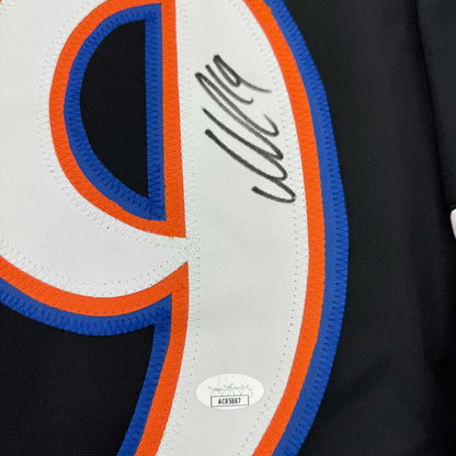 Black jersey with white, orange, blue number 9 and signature from a pro sports league