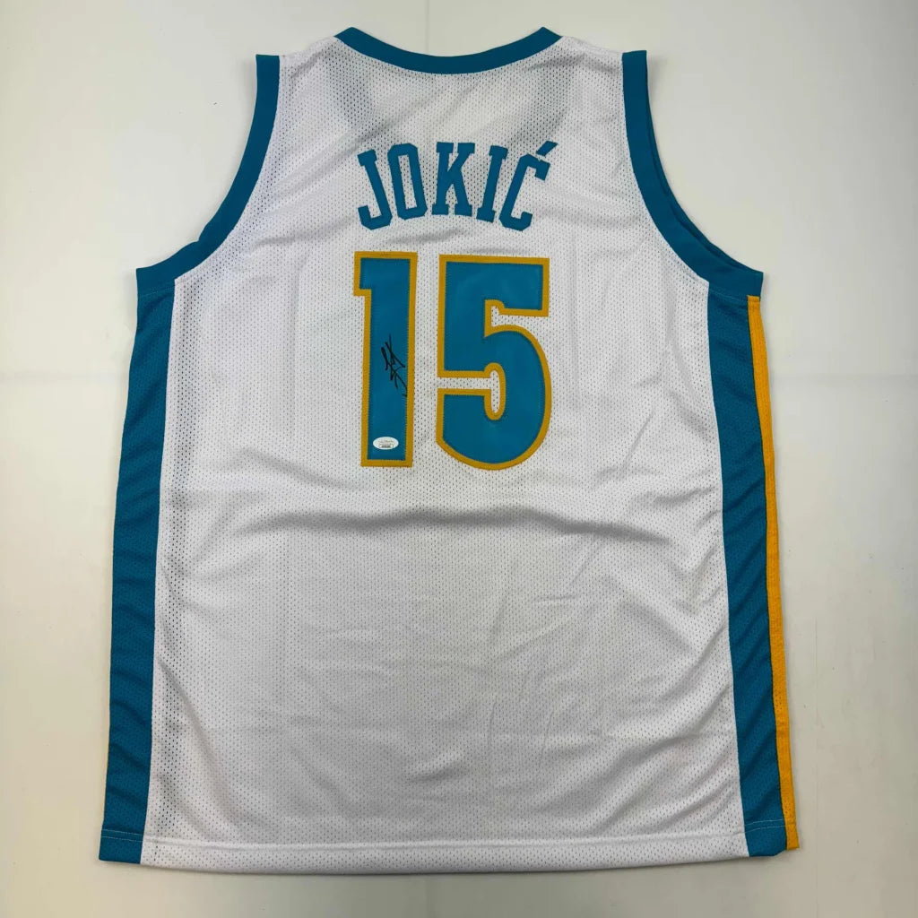 White custom basketball jersey with JOKIĆ 15 and faint signature for professional sports fans
