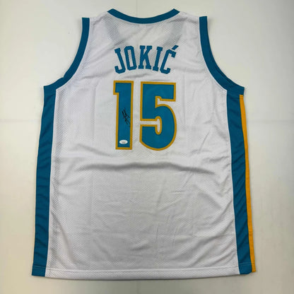 White custom basketball jersey with JOKIĆ 15 and faint signature for professional sports fans