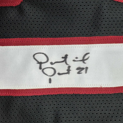 Black custom jersey with red and white stripe and autograph from a professional sports league