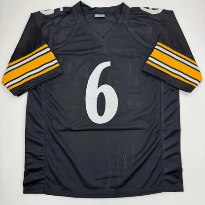 Black custom jersey with white number 6 and yellow white striped sleeves for sports league