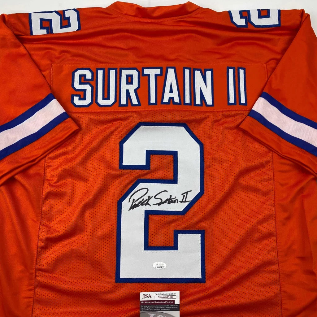 Back of autographed orange denver retro football custom jersey with white and blue surtain ii 2 lettering from professional sports league