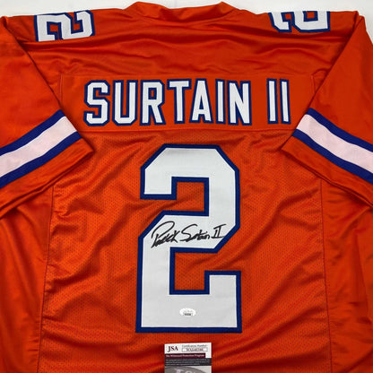 Back of autographed orange denver retro football custom jersey with white and blue surtain ii 2 lettering from professional sports league