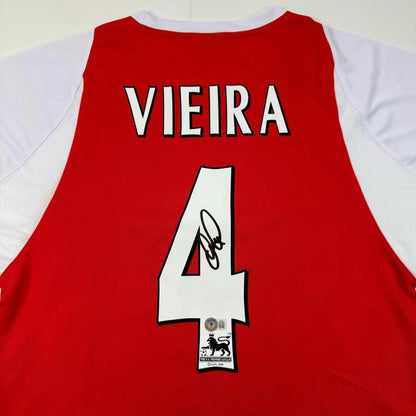 Back of a red and white arsenal custom jersey featuring patrick vieira number 4 with autograph for professional sports league