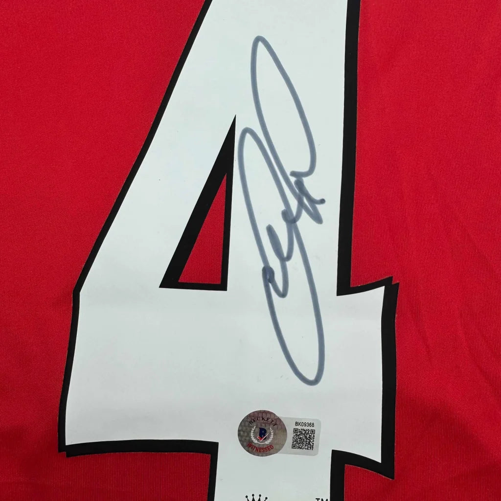 Red sports jersey with white number 4 and black autograph from professional sports league