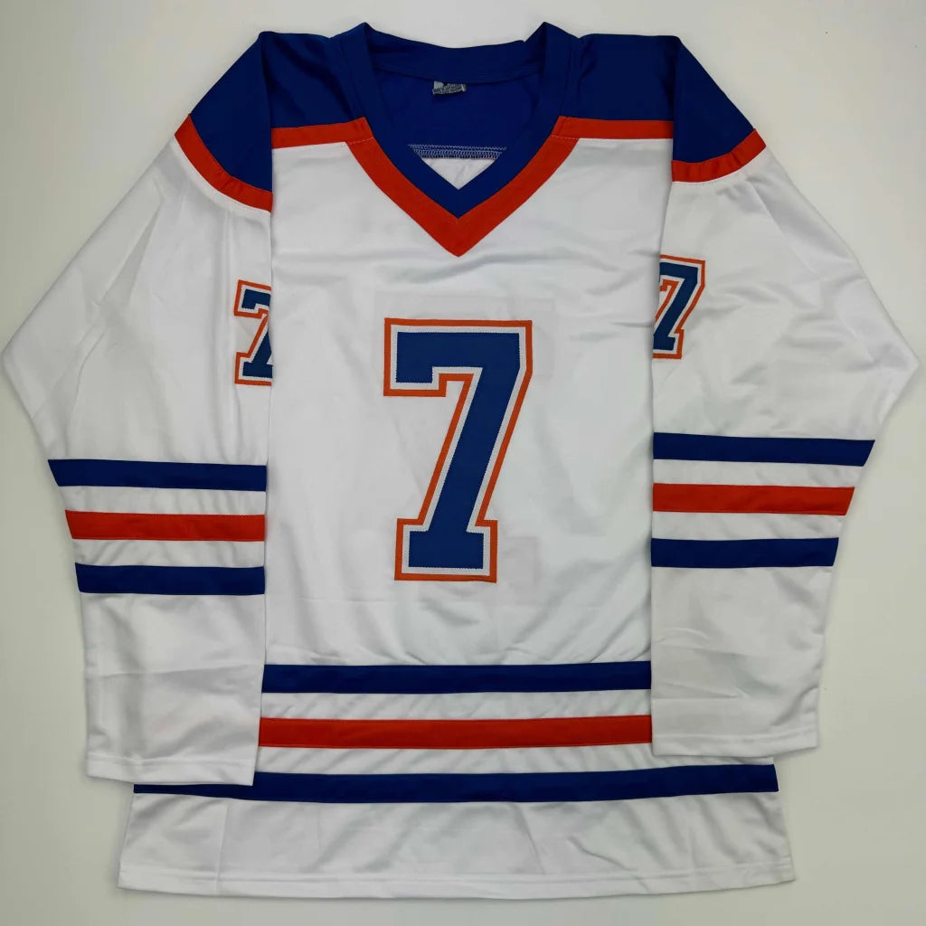 White hockey jersey with blue and orange trim and number 7 from Professional Sports League