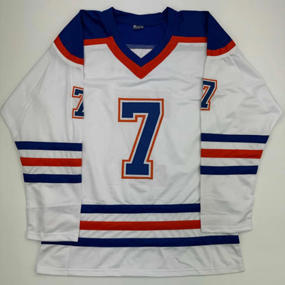 White hockey jersey with blue and orange trim and number 7 from Professional Sports League