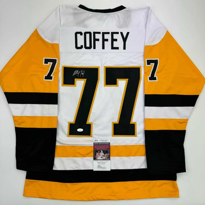 Back of a white yellow and black pittsburgh penguins custom jersey with coffey 77 signed for professional sports league