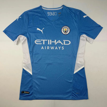 Light blue short-sleeved Manchester City jersey with white accents, third party authentication