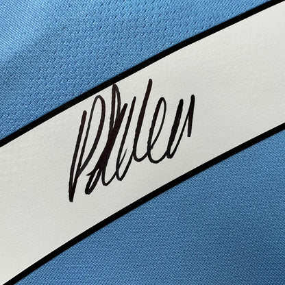 Light blue Manchester City jersey with white stripe and black autograph, third party authentication