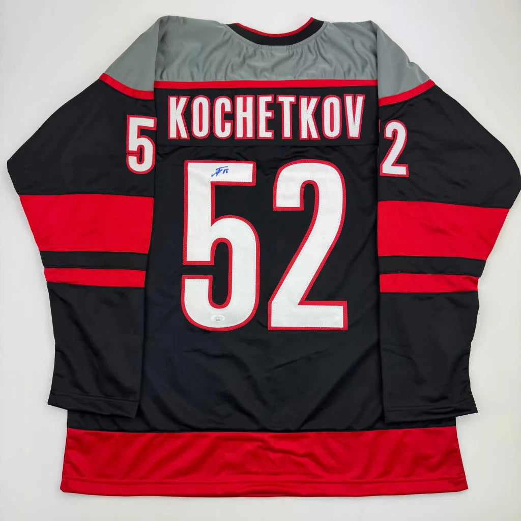Autographed Pyotr Kochetkov custom black Carolina jersey with red accents, number 52
