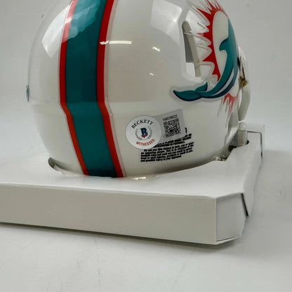 White Miami Dolphins mini helmet with teal and orange stripes and dolphin logo in display case