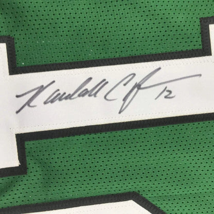 Green sports jersey with white stripe and autograph from Randall Cunningham, a pro sports league item