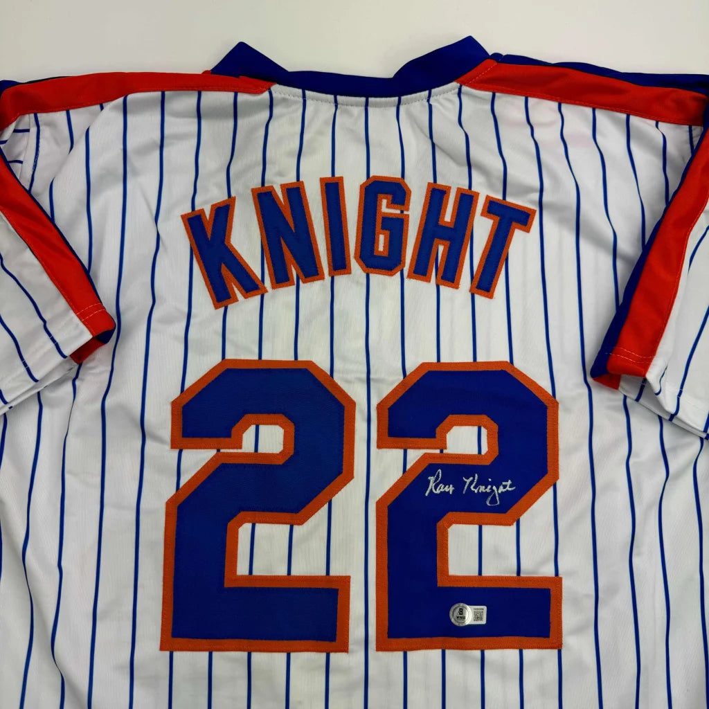 White pinstriped custom jersey with blue and orange lettering, autographed, for professional sports fans