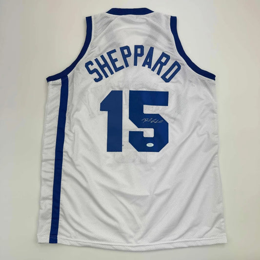 White and blue professional sports league jersey with number 15 and signature