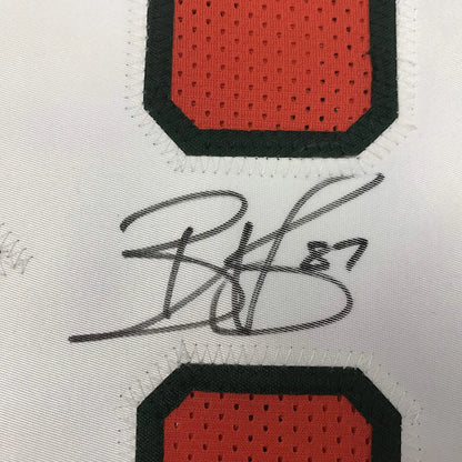 Autographed black ink signature on white mesh basketball custom jersey with red and black numbered patches from professional sports league