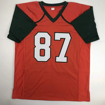 Autographed red and black custom jersey with white number 87 from professional sports league featuring reggie wayne