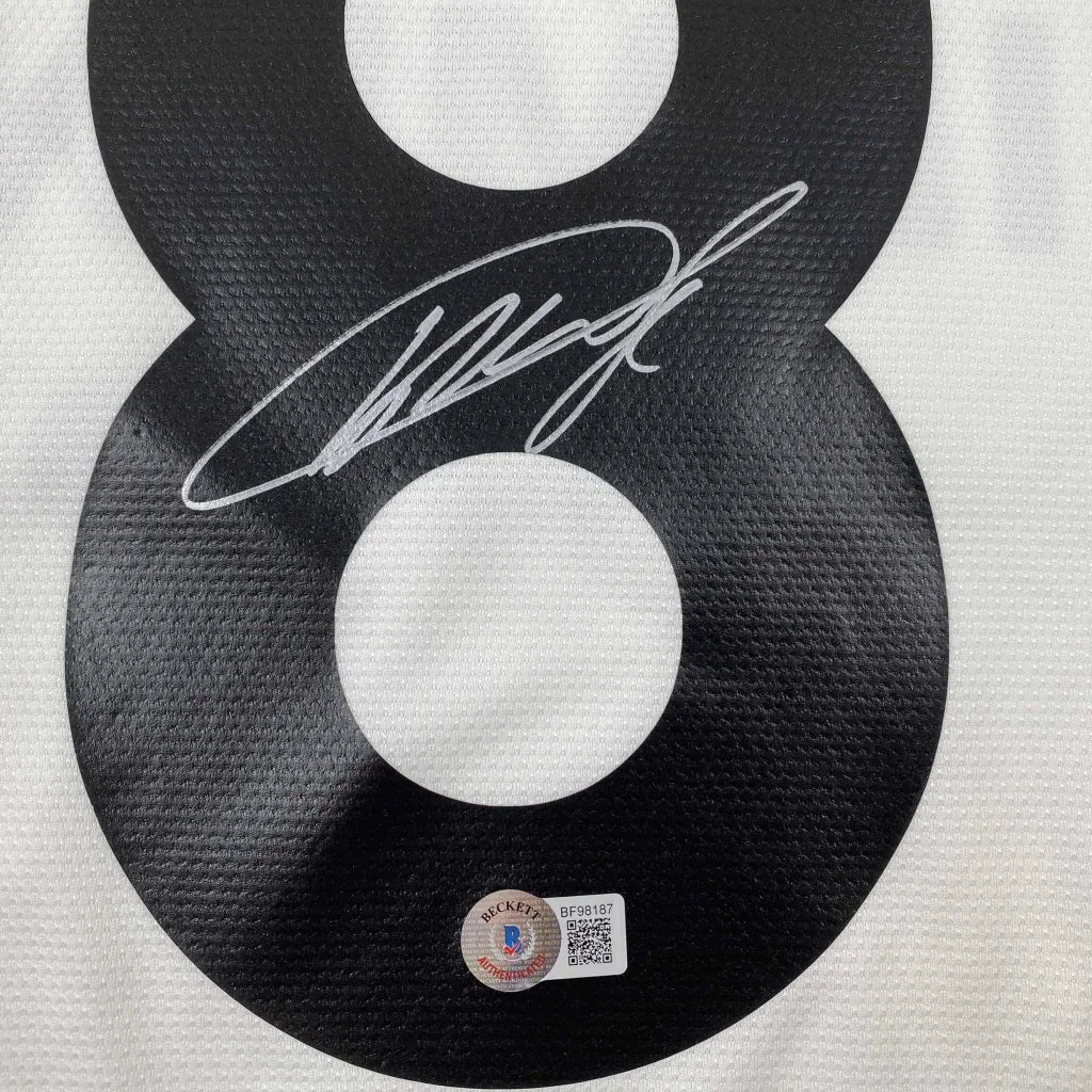 Black KAKA signed soccer jersey with white autograph and official authenticity sticker