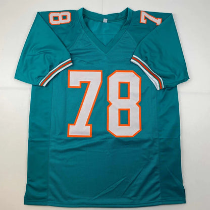 Teal Miami Dolphins custom jersey with white and orange 78 numerals from professional sports league