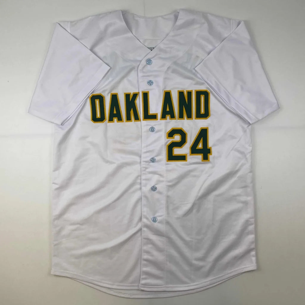 White baseball jersey with green and yellow Oakland 24 lettering from a professional sports league