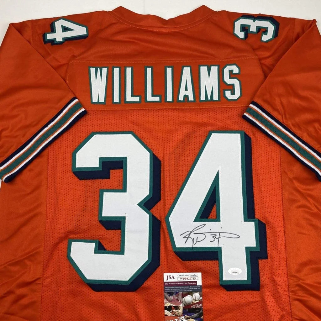 Back of orange miami dolphins custom jersey signed by ricky williams with white and teal lettering number 34 professional sports league