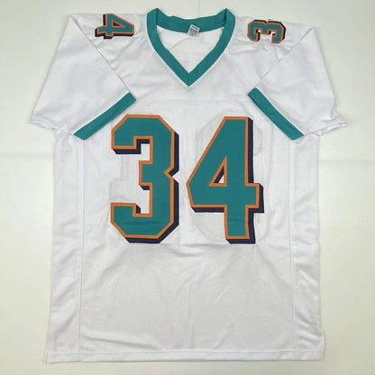 Autographed ricky williams miami white custom football jersey with teal and orange numerals from professional sports league