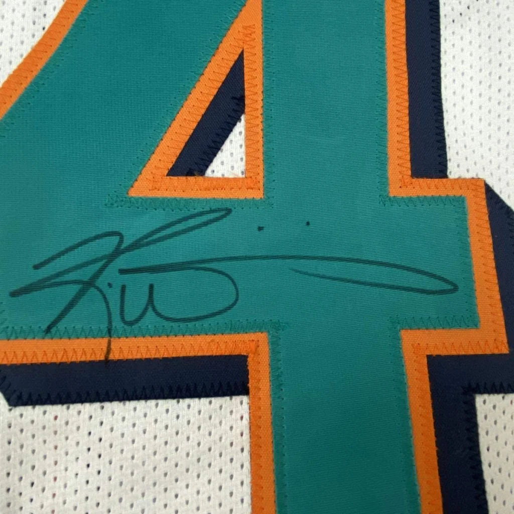 Autographed teal and orange number four patch with black signature on custom ricky williams miami football jersey