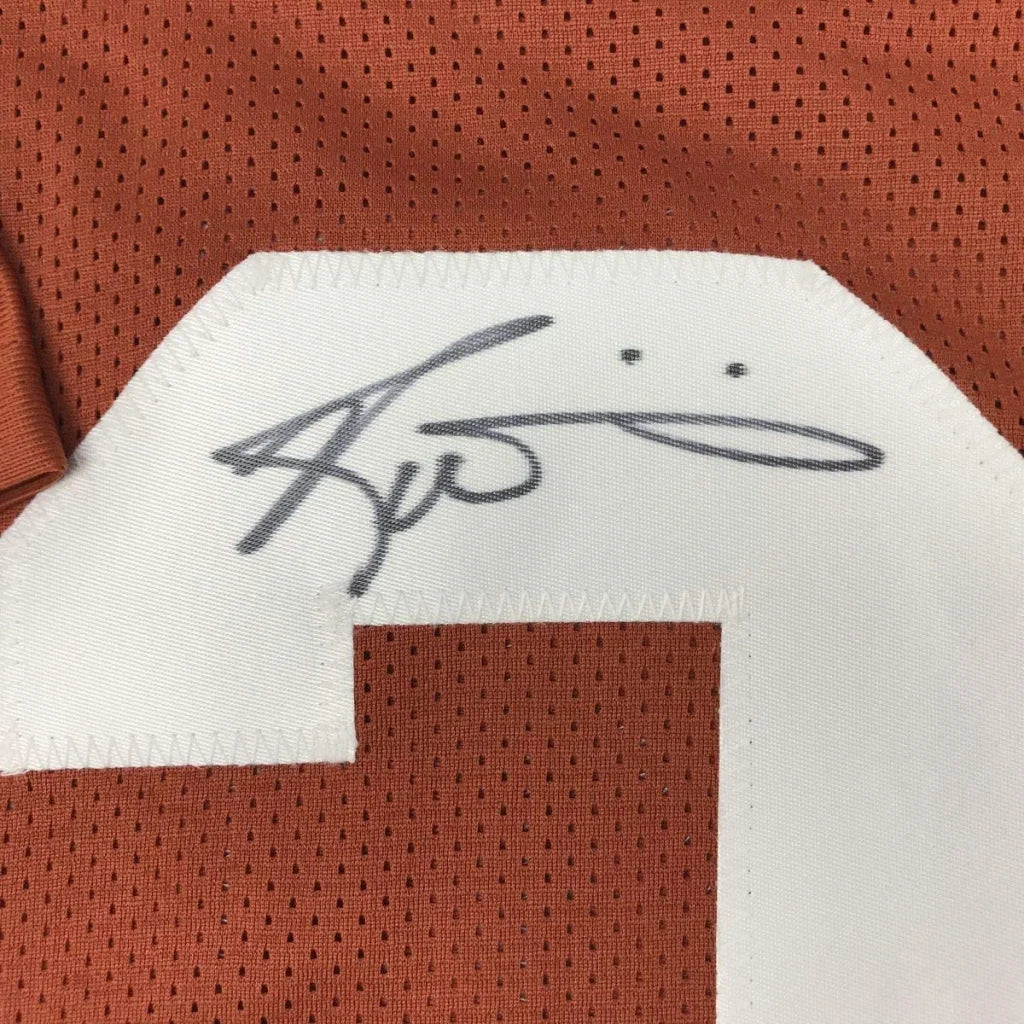 Autographed orange Texas Longhorns sports jersey from a professional sports league