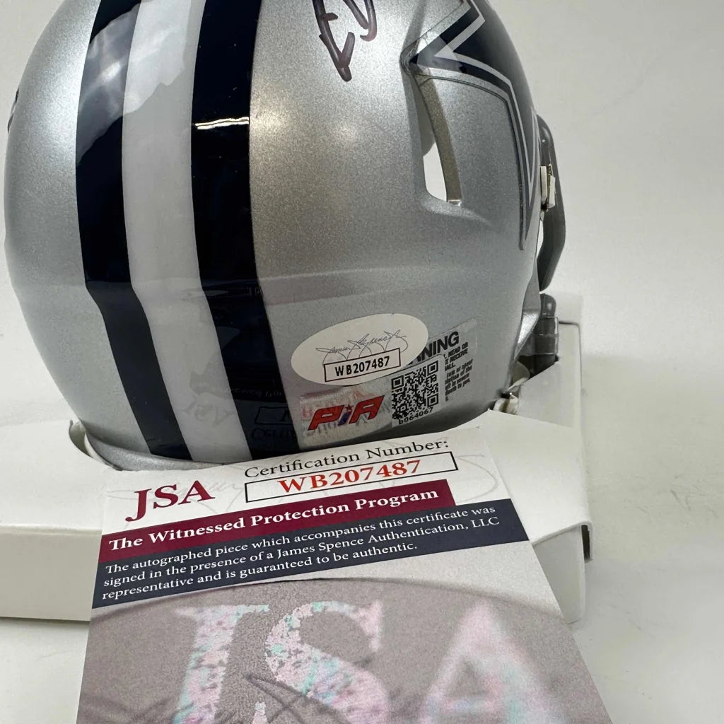 Silver Dallas Cowboys mini helmet with dark stripes and third party authentication badge