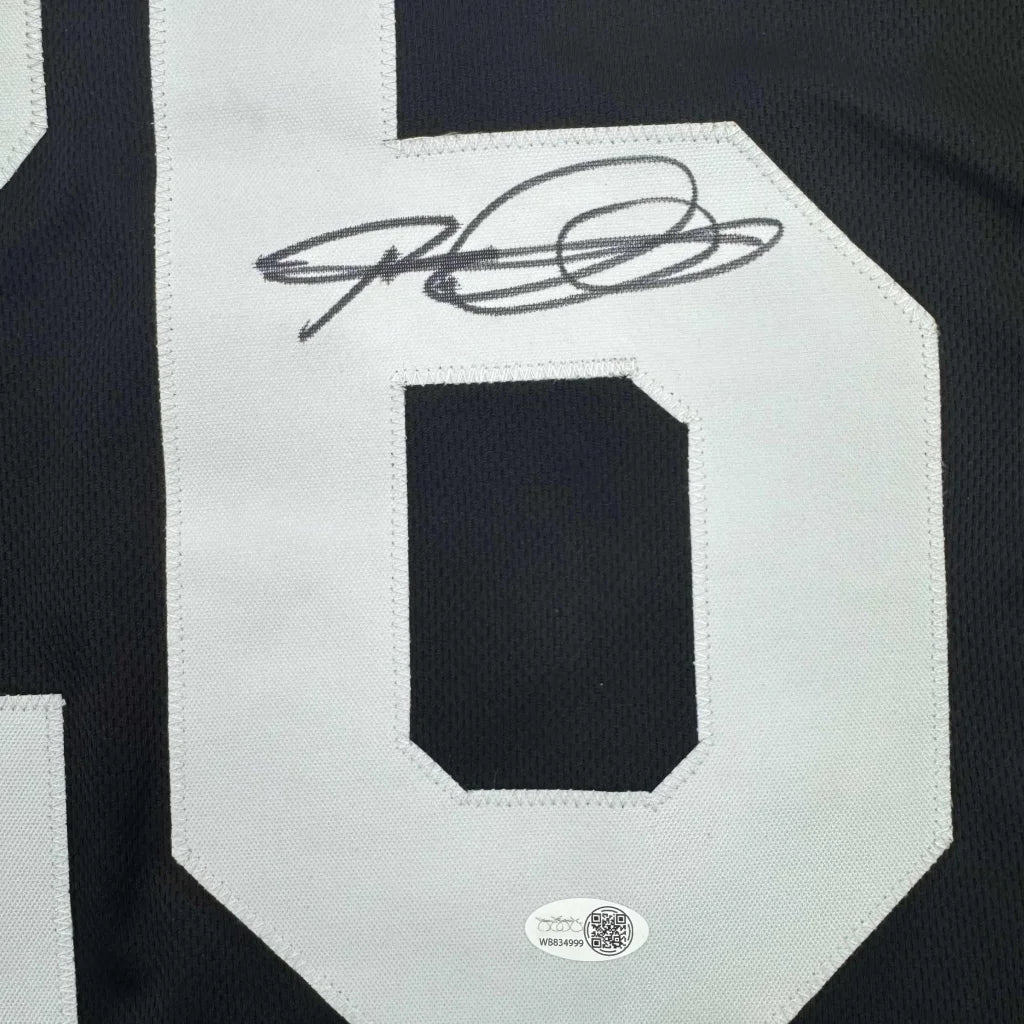 Black and white professional sports league custom jersey with signature from Woodson 26