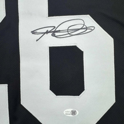 Black and white professional sports league custom jersey with signature from Woodson 26